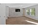 Bright and spacious living room with hard surface floors, modern accent wall, and ample sunlight at 3 Windsor Ct, Kingston, GA 30145