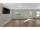 Spacious living area showcasing a stylish accent wall, hard surface flooring and abundant natural light at 3 Windsor Ct, Kingston, GA 30145
