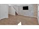 Living room features hard surface flooring, an accent wall, and easy access to stairs and door at 3 Windsor Ct, Kingston, GA 30145