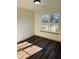 Bedroom featuring a large window and hardwood floors at 415 Dove Ln, Social Circle, GA 30025