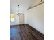 Inviting dining room with dark wood floors, modern light fixture and natural light at 415 Dove Ln, Social Circle, GA 30025