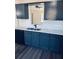 Modern kitchen features stylish blue cabinets, stainless steel appliances, and Quartz countertops at 415 Dove Ln, Social Circle, GA 30025