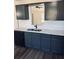 Modern kitchen features stylish blue cabinets, stainless steel appliances, and Quartz countertops at 415 Dove Ln, Social Circle, GA 30025