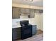 Modern kitchen features sleek gray cabinets, stainless steel appliances, and Quartz countertops at 415 Dove Ln, Social Circle, GA 30025