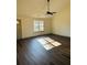 Bright living room featuring hardwood floors, a modern ceiling fan, and large windows at 415 Dove Ln, Social Circle, GA 30025