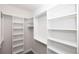Walk in closet with ample shelving and hanging storage and gray wood floors at 530 Fisher Dr # 45, Alpharetta, GA 30009