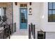 Charming light blue front door with glass panes, black lantern, and brick facade at 530 Fisher Dr # 45, Alpharetta, GA 30009