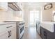 Modern kitchen with stainless steel appliances, a farmhouse sink, and a tiled backsplash at 530 Fisher Dr # 45, Alpharetta, GA 30009