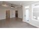 Spacious living room featuring tray ceilings, ceiling fan, gray wood floors and access to a balcony at 530 Fisher Dr # 45, Alpharetta, GA 30009