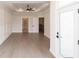 Spacious living room featuring tray ceilings, ceiling fan, gray wood floors and access to a balcony at 530 Fisher Dr # 45, Alpharetta, GA 30009
