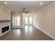 Bright living room with a modern fireplace, large windows, and wood floors at 530 Fisher Dr # 45, Alpharetta, GA 30009