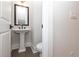 Compact powder room featuring a pedestal sink, toilet, and modern fixtures at 530 Fisher Dr # 45, Alpharetta, GA 30009