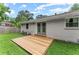 Back exterior view featuring a wooden deck, brick facade, and lush green lawn at 2756 Gresham Se Rd, Atlanta, GA 30316