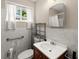 Cozy bathroom with white marble-style tiling, modern vanity, toilet, and well lit mirror at 2756 Gresham Se Rd, Atlanta, GA 30316