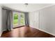 Charming bedroom with hardwood floors and french doors leading to the lush green backyard at 2756 Gresham Se Rd, Atlanta, GA 30316