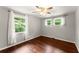 This bedroom features gleaming hardwood floors, neutral walls, and a ceiling fan with light fixture at 2756 Gresham Se Rd, Atlanta, GA 30316
