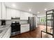 Updated kitchen featuring white cabinets, granite countertops, and stainless steel appliances at 2756 Gresham Se Rd, Atlanta, GA 30316