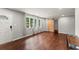 Spacious living room with hardwood floors, fresh paint, three windows, and a decorative sliding barn door at 2756 Gresham Se Rd, Atlanta, GA 30316