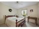 Cozy bedroom features a wooden bed frame and neutral-toned walls with natural light at 291 N Briar Rdg, Woodstock, GA 30189