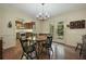 Bright dining room features hardwood floors, classic chandelier, and access to screened-in porch at 291 N Briar Rdg, Woodstock, GA 30189