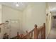 Entryway with wooden railing leading to the main level and a view of the front door at 291 N Briar Rdg, Woodstock, GA 30189