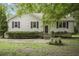 Charming one-story home with light-colored siding, red shutters, and mature landscaping at 291 N Briar Rdg, Woodstock, GA 30189