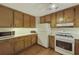 Functional kitchen featuring wood cabinets, white appliances, and a bright, clean space at 291 N Briar Rdg, Woodstock, GA 30189
