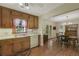 An open kitchen with wood cabinets, white appliances, and a view to the dining area at 291 N Briar Rdg, Woodstock, GA 30189