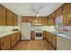 Functional kitchen featuring wood cabinets, white appliances, and a bright, clean space at 291 N Briar Rdg, Woodstock, GA 30189