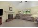 Comfortable living room showcasing a fireplace with brick detail and a large picture window at 291 N Briar Rdg, Woodstock, GA 30189