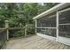 View of the screened porch from the deck, offering an outdoor entertaining area at 291 N Briar Rdg, Woodstock, GA 30189