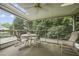 Relaxing screened porch with a table and seating, perfect for enjoying the outdoors at 291 N Briar Rdg, Woodstock, GA 30189