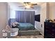 Comfortable bedroom features a large bed, plush carpeting, and a ceiling fan at 3060 Pharr Court North Nw # 719, Atlanta, GA 30305