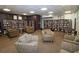 Library with ample seating, tables, and floor-to-ceiling bookshelves filled with books at 3060 Pharr Court North Nw # 719, Atlanta, GA 30305