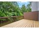 Wooden back deck with a brown privacy fence and green tree views at 760 Celeste Sw Ln, Atlanta, GA 30331