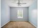 Empty bedroom featuring a window and a ceiling fan and light fixture at 760 Celeste Sw Ln, Atlanta, GA 30331