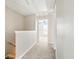 Hallway with neutral walls and carpet, leading to other rooms, and multiple doors at 760 Celeste Sw Ln, Atlanta, GA 30331