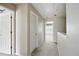 Hallway with neutral walls and carpet, leading to other rooms, and multiple doors at 760 Celeste Sw Ln, Atlanta, GA 30331