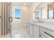 Modern bathroom featuring a glass shower, marble floors, and a sleek vanity with a large mirror at 260 Guild Ln, Fayetteville, GA 30214