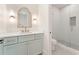 Bathroom with a glass shower, modern vanity, stylish mirror and sconces at 260 Guild Ln, Fayetteville, GA 30214
