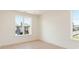Well-lit bedroom featuring light hardwood floors and large windows with neighborhood views at 260 Guild Ln, Fayetteville, GA 30214