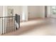 Upstairs hallway with wood floors and a black metal railing, showcasing the bright, open layout at 260 Guild Ln, Fayetteville, GA 30214