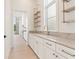 Bright kitchen area with marble countertops, modern cabinets, gold fixtures and stylish floating shelves at 260 Guild Ln, Fayetteville, GA 30214