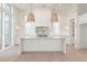 Modern kitchen features a center island, stylish lighting, and white cabinetry at 260 Guild Ln, Fayetteville, GA 30214