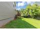 Backyard featuring a lush lawn, a wooden deck with stairs, and mature trees at 409 Ivy Terrace Dr, Dallas, GA 30157