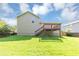 Large backyard featuring a deck with stairs, green grass, and privacy fencing at 409 Ivy Terrace Dr, Dallas, GA 30157