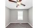 This bright bedroom features a ceiling fan, window and plush carpet at 409 Ivy Terrace Dr, Dallas, GA 30157