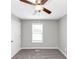 Neutral bedroom with gray carpet and a large window providing natural light at 409 Ivy Terrace Dr, Dallas, GA 30157