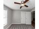 This cozy bedroom features plush carpet, a window and a ceiling fan at 409 Ivy Terrace Dr, Dallas, GA 30157