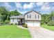 Charming home with gray siding, a well-manicured lawn, and a two-car garage at 409 Ivy Terrace Dr, Dallas, GA 30157